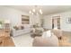 Bright living room with hardwood floors, stylish decor, and comfortable, neutral furniture at 426 Walden Trl, Waxhaw, NC 28173