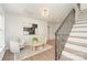 Bright, inviting living space with staircase, hardwood floors and modern lighting at 426 Walden Trl, Waxhaw, NC 28173