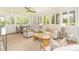 Sunroom featuring neutral furnishings, a ceiling fan, and many windows for natural light at 426 Walden Trl, Waxhaw, NC 28173