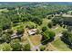 Expansive aerial view of the property showcasing the land, outbuildings, and surrounding greenery at 4734 Polk Ford Rd, Stanfield, NC 28163
