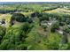 Lush landscape with a pond, mature trees, and multiple outbuildings, offering a serene setting at 4734 Polk Ford Rd, Stanfield, NC 28163