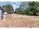 The backyard features an expansive grassy area, fenced perimeter, mature trees and a shed at 4734 Polk Ford Rd, Stanfield, NC 28163