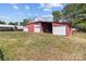 The barn features a red exterior with multiple white garage doors on a grassy lot at 4734 Polk Ford Rd, Stanfield, NC 28163