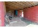 The barn interior has a dirt floor, wood framing, red siding, and an open back door at 4734 Polk Ford Rd, Stanfield, NC 28163