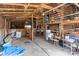 Inside this barn is a cement floor, exposed wood beams, and stored tables and chairs at 4734 Polk Ford Rd, Stanfield, NC 28163
