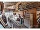 The barn interior has an unfinished ceiling, exposed wood beam structure, and various stored objects at 4734 Polk Ford Rd, Stanfield, NC 28163