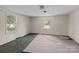 This bedroom features two windows and carpeted flooring, needs some TLC at 4734 Polk Ford Rd, Stanfield, NC 28163