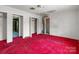 Bedroom with red carpet, closet, and attached bathroom at 4734 Polk Ford Rd, Stanfield, NC 28163