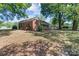 Brick single story home with covered porch and mature trees at 4734 Polk Ford Rd, Stanfield, NC 28163