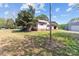 Exterior view of home with faded siding, barn and storage shed at 4734 Polk Ford Rd, Stanfield, NC 28163