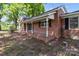 Charming brick home featuring a covered front porch with white columns and ample space at 4734 Polk Ford Rd, Stanfield, NC 28163