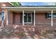 Front of a brick house with sliding glass doors and a covered brick porch at 4734 Polk Ford Rd, Stanfield, NC 28163