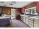 Kitchen featuring wood paneling, white counters and sink, and view to dining room at 4734 Polk Ford Rd, Stanfield, NC 28163