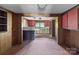 Kitchen features wood paneling and view to dining room and other side of kitchen at 4734 Polk Ford Rd, Stanfield, NC 28163