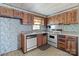 Outdated kitchen with wood cabinets and white appliances at 4734 Polk Ford Rd, Stanfield, NC 28163