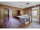 Kitchen featuring wood paneling, cooktop, and view to dining room at 4734 Polk Ford Rd, Stanfield, NC 28163