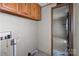 Bare laundry room with exposed plumbing and outdated cabinets at 4734 Polk Ford Rd, Stanfield, NC 28163
