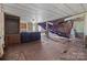 View of damaged living room with visible ceiling and floor damage at 4734 Polk Ford Rd, Stanfield, NC 28163