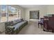 Living room featuring a floral couch, piano, and large window at 4734 Polk Ford Rd, Stanfield, NC 28163