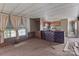View of damaged living room with outdated decor and carpet at 4734 Polk Ford Rd, Stanfield, NC 28163