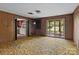 This living room features wood paneling, built in shelving and a sliding glass door to the backyard at 4734 Polk Ford Rd, Stanfield, NC 28163