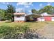 Property featuring multiple outbuildings including a metal carport and a red barn at 4734 Polk Ford Rd, Stanfield, NC 28163