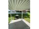 Covered patio with grill overlooking spacious backyard with white fence, great for outdoor entertaining at 5012 Wheat Sw Dr, Concord, NC 28027