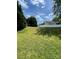 Expansive backyard with healthy green lawn, surrounded by a white fence and mature trees at 5012 Wheat Sw Dr, Concord, NC 28027