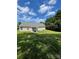 View of house exterior from the backyard, including patio, lush lawn, and mature trees at 5012 Wheat Sw Dr, Concord, NC 28027