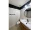 Bathroom featuring a dark accent stripe, round mirror, and black hardware at 5012 Wheat Sw Dr, Concord, NC 28027