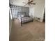 A serene bedroom featuring natural light and a decorative wall and ceiling fan at 5012 Wheat Sw Dr, Concord, NC 28027