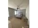 Comfortable bedroom featuring a ceiling fan, patterned accent wall, and neutral carpet at 5012 Wheat Sw Dr, Concord, NC 28027