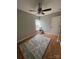 Neutral bedroom showcasing wooden floors and ceiling fan at 5012 Wheat Sw Dr, Concord, NC 28027