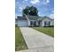 Charming single-story home with a well-manicured lawn, paved driveway, and attached garage at 5012 Wheat Sw Dr, Concord, NC 28027