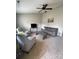 Cozy living room with a ceiling fan, plush carpeting, and plenty of natural light creating an inviting space at 5012 Wheat Sw Dr, Concord, NC 28027