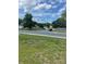Residential street view with well-maintained lawns, mature trees, and a vehicle at the intersection at 5012 Wheat Sw Dr, Concord, NC 28027