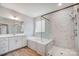 Luxurious bathroom with separate tub and shower, double vanity, and sleek fixtures at 5027 Mclaughlin Loop # 61, Waxhaw, NC 28173