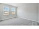 Bright bedroom featuring carpet, fresh paint and natural light from two double hung windows at 5027 Mclaughlin Loop # 61, Waxhaw, NC 28173
