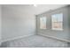 Bright bedroom with neutral carpet, fresh paint, and natural light from two windows at 5027 Mclaughlin Loop # 61, Waxhaw, NC 28173