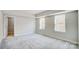 Well-lit bedroom featuring two windows, neutral wall color, and carpeted floor at 5027 Mclaughlin Loop # 61, Waxhaw, NC 28173