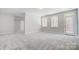 Bright bedroom with plush carpeting, natural light from windows, and access door at 5027 Mclaughlin Loop # 61, Waxhaw, NC 28173