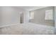 Bright bedroom with neutral paint, plush gray carpet and walk-in closet at 5027 Mclaughlin Loop # 61, Waxhaw, NC 28173