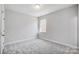 Minimalist bedroom with neutral carpet and single window at 5027 Mclaughlin Loop # 61, Waxhaw, NC 28173