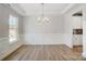 Formal dining room featuring modern chandelier, wainscoting, and adjacent kitchen area at 5027 Mclaughlin Loop # 61, Waxhaw, NC 28173