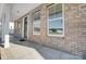 Inviting front porch with brick accents, a black front door, and large windows at 5027 Mclaughlin Loop # 61, Waxhaw, NC 28173