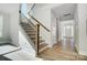 Inviting hallway featuring hardwood floors and staircase with natural light at 5027 Mclaughlin Loop # 61, Waxhaw, NC 28173