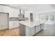 Open concept kitchen features a large central island, stainless appliances, and a stylish backsplash at 5027 Mclaughlin Loop # 61, Waxhaw, NC 28173