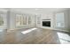 Bright living room with a modern fireplace, large windows, and wood floors at 5027 Mclaughlin Loop # 61, Waxhaw, NC 28173