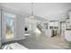 Spacious open-concept living area, connecting the kitchen, living room and dining area with fireplace and staircase at 5027 Mclaughlin Loop # 61, Waxhaw, NC 28173
