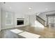Spacious living room featuring a fireplace, large windows, and staircase to upper floors at 5027 Mclaughlin Loop # 61, Waxhaw, NC 28173